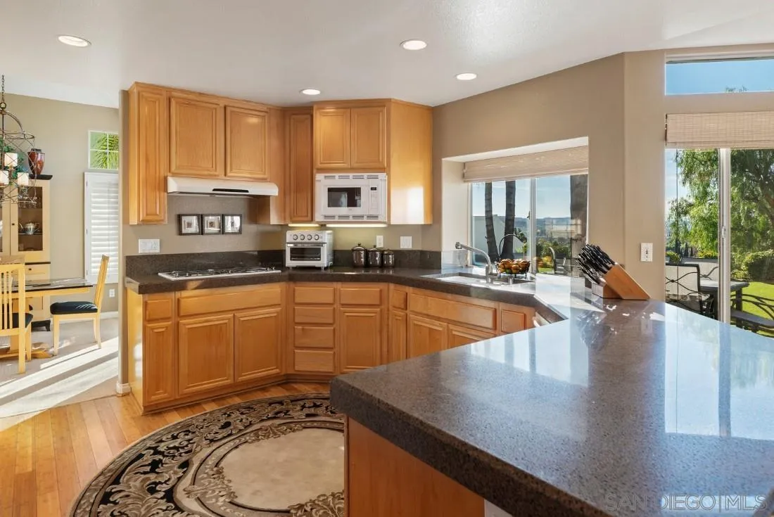14268 Silver Ridge Road Poway, CA 92064 - Photo 17 of 53 a large kitchen with stainless steel appliances a large window and a counter space