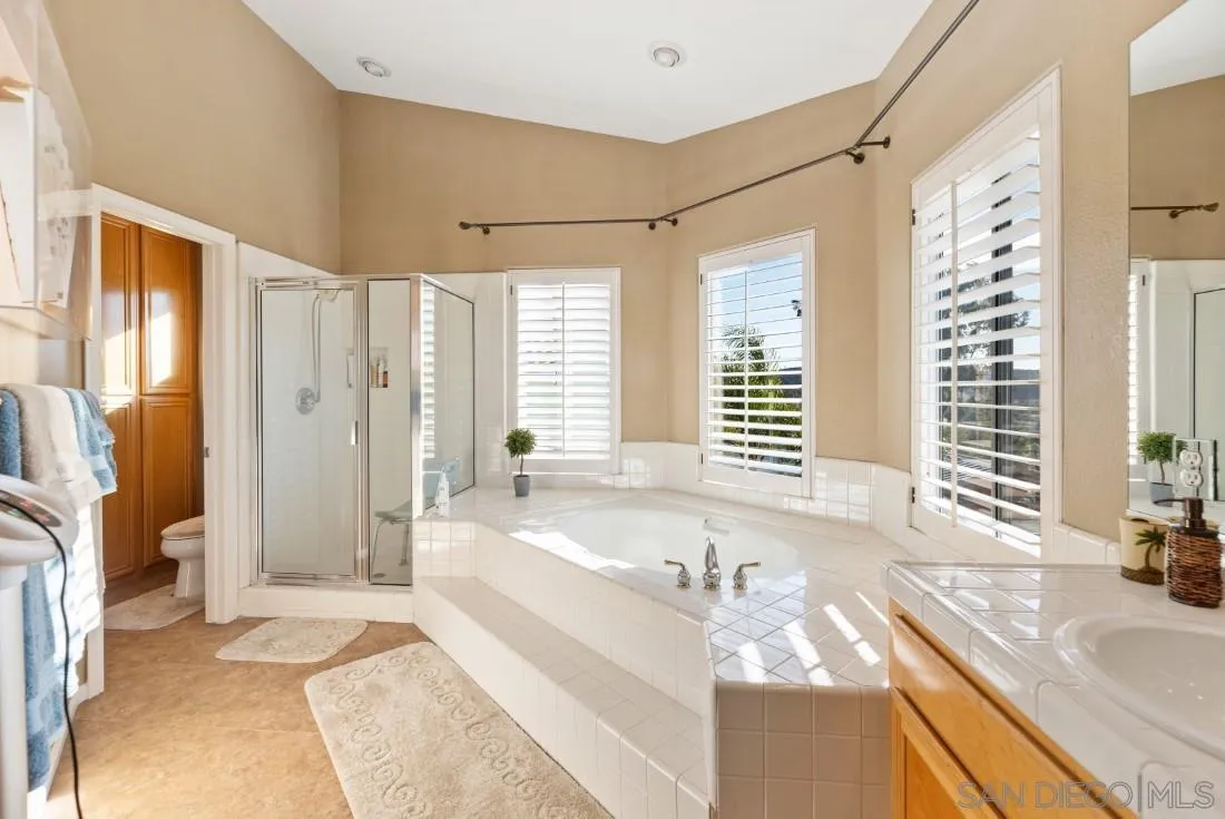 14268 Silver Ridge Road Poway, CA 92064 - Photo 44 of 53 a spacious bathroom with a granite countertop tub sink and a shower
