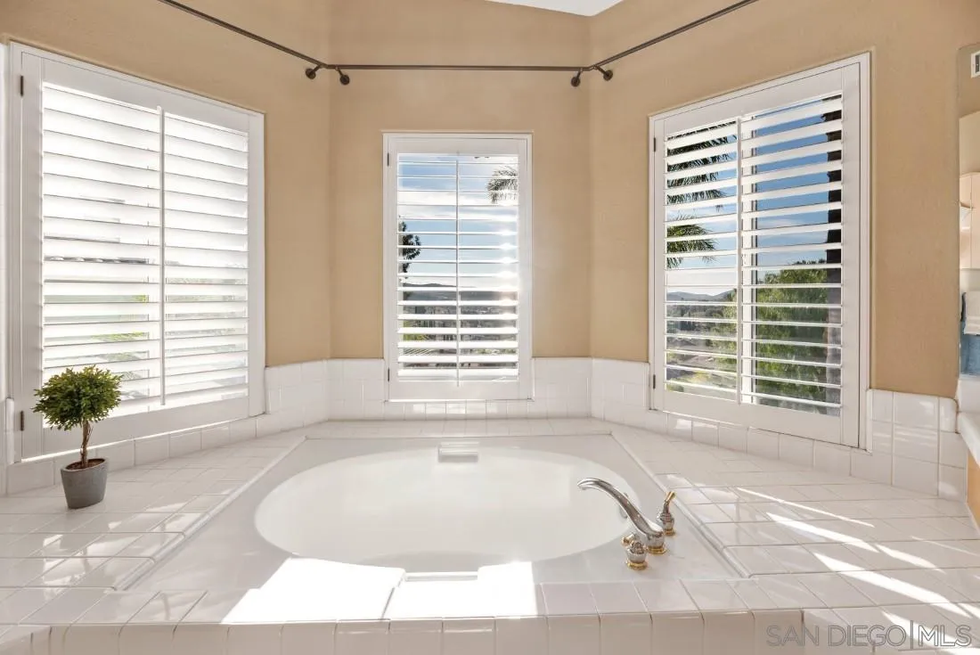 14268 Silver Ridge Road Poway, CA 92064 - Photo 45 of 53 a bathroom with a bathtub and window
