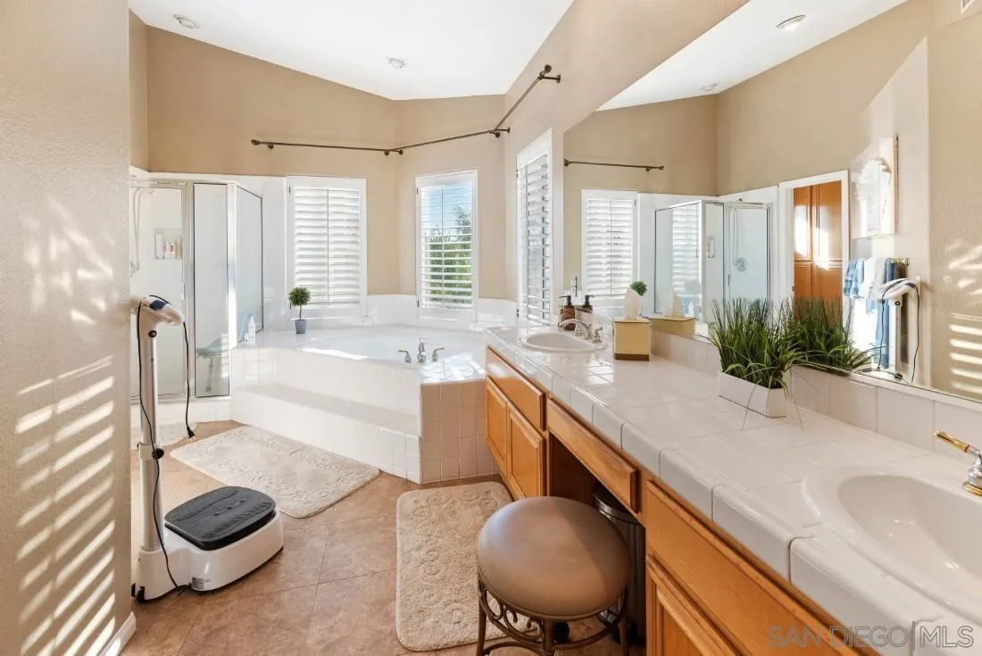 14268 Silver Ridge Road Poway, CA 92064 - Photo 46 of 53 a spacious bathroom with a tub sink and mirror