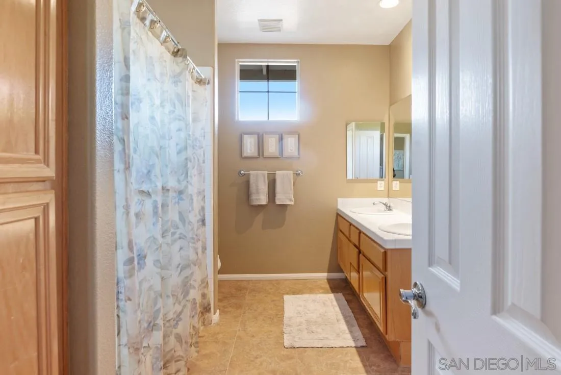 14268 Silver Ridge Road Poway, CA 92064 - Photo 49 of 53 a bathroom with a sink and a tub