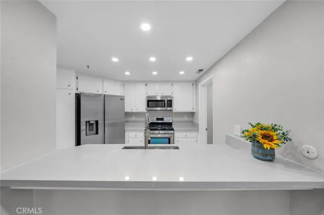 a kitchen with stainless steel appliances a refrigerator and a stove