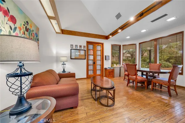 a living room with furniture and floor to ceiling window