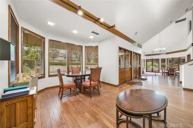a dining room with furniture window and wooden floor