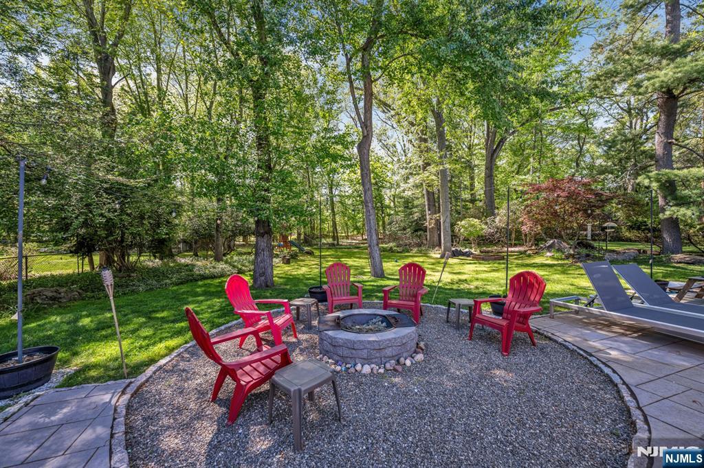 433 Piermont Road Cresskill, NJ 07626 - Photo 43 of 49 a backyard of a house with fountain table and chairs