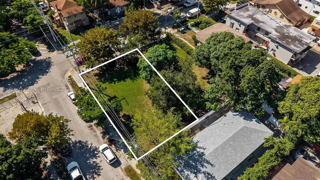 an aerial view of a residential houses with outdoor space