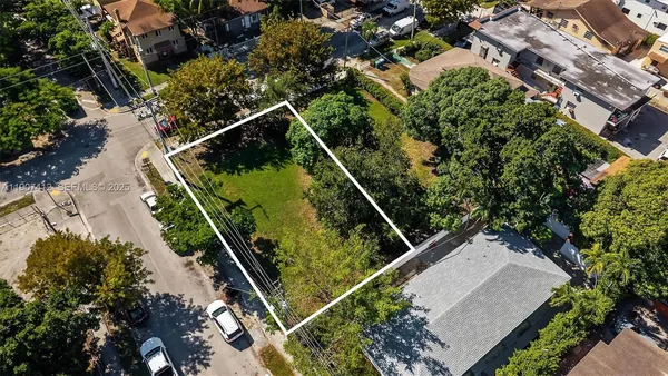 an aerial view of a residential houses with outdoor space