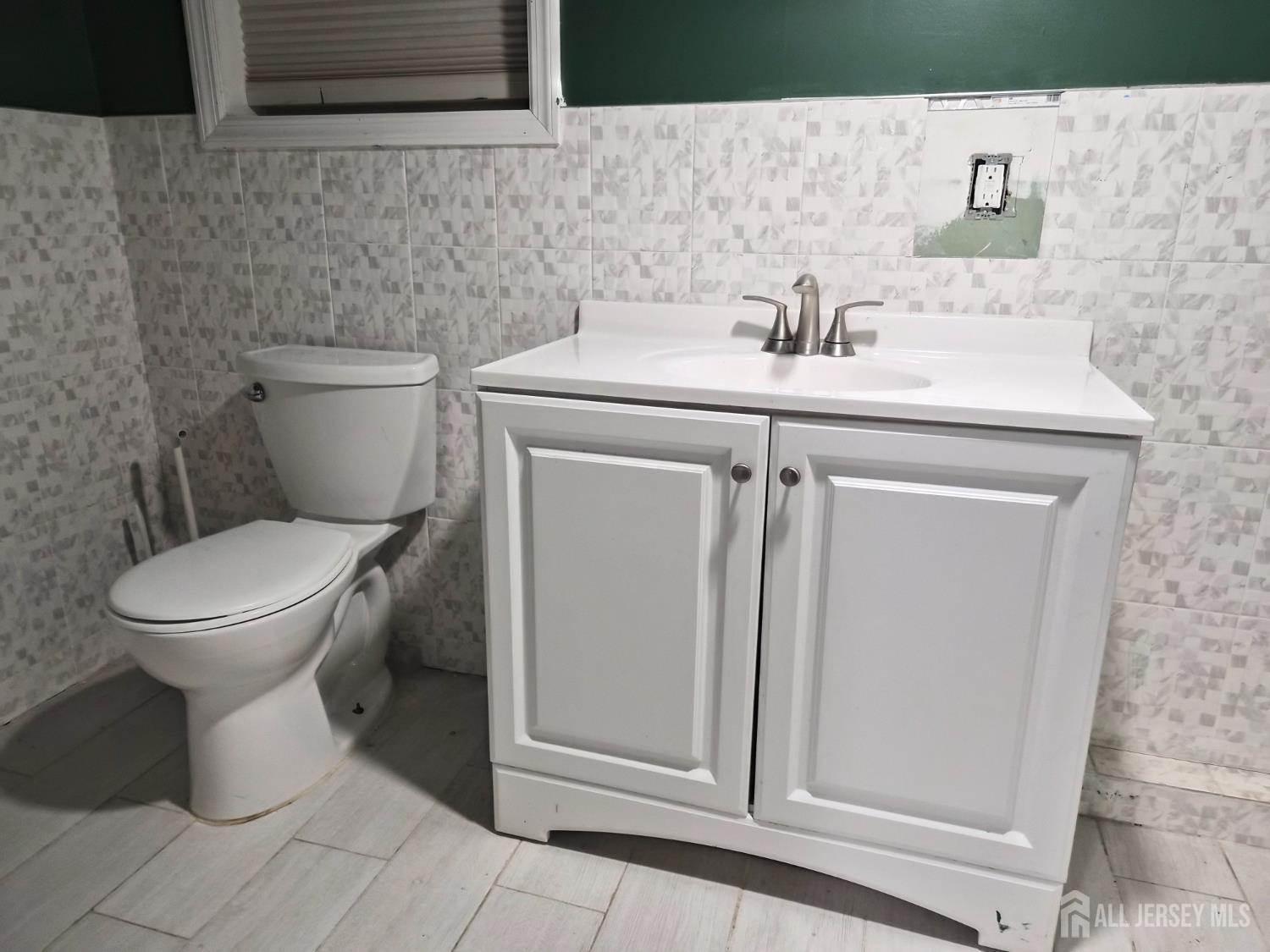 95 Farragut Road North Plainfield, NJ 07060 - Photo 12 of 30 a bathroom with a sink a toilet and mirror