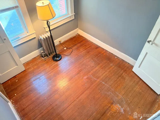 a view of a room with wooden floor