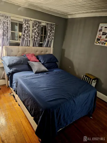 a bed sitting in a bedroom next to a window