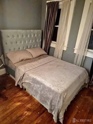 a bedroom with a bed and a mirror