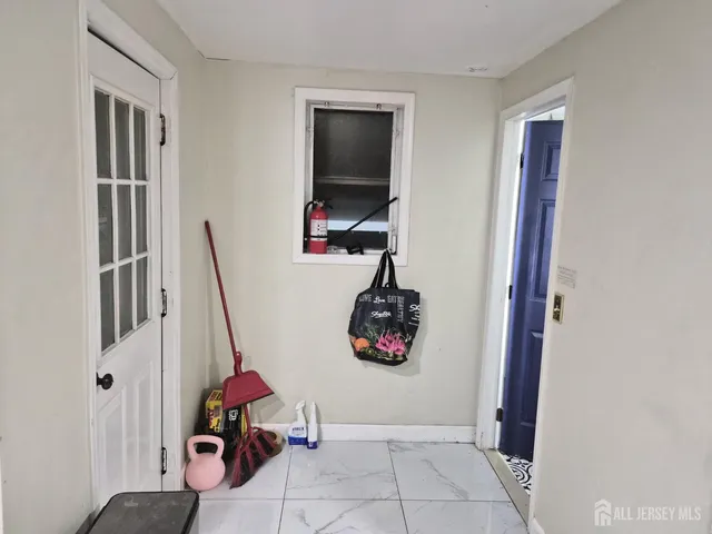 a view of storage and utility room with a window