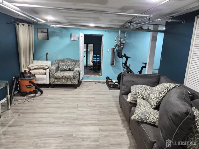 a living room with furniture and a mirror