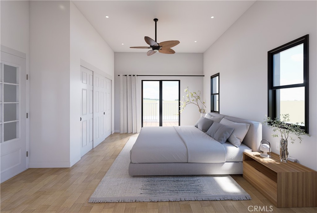 31302 Andres Pico Road San Juan Capistrano, CA 92675 - Photo 14 of 33 a bedroom with a large bed and a chandelier