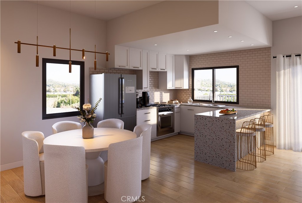 31302 Andres Pico Road San Juan Capistrano, CA 92675 - Photo 8 of 23 a kitchen with kitchen island a counter top space a sink stainless steel appliances and windows