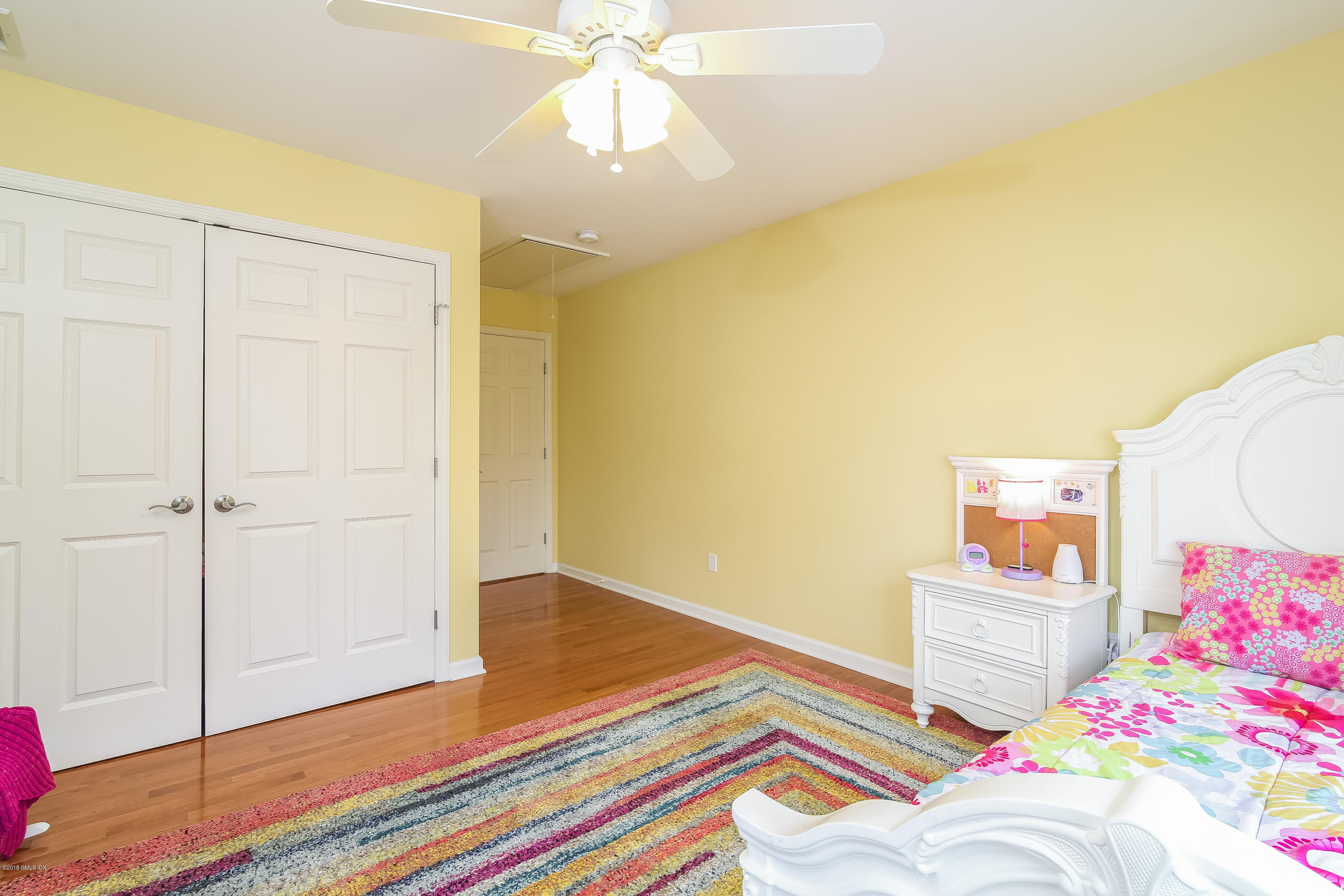 68 Sheep Hill Road Riverside, CT 06878 - Photo 30 of 38 a bedroom with a bed and a chandelier