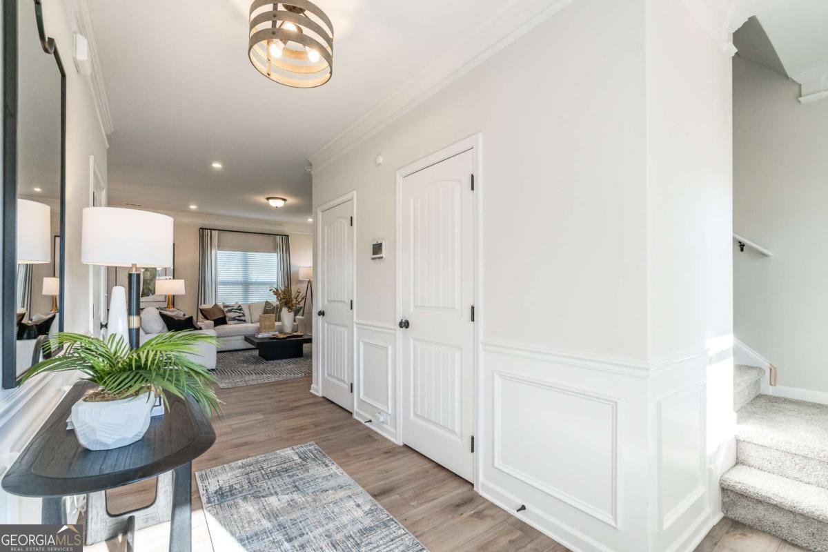 10413 Trellis Lane, Unit (LOT 33) Hampton, GA 30228 - Photo 11 of 39 a living room with furniture and a potted plant