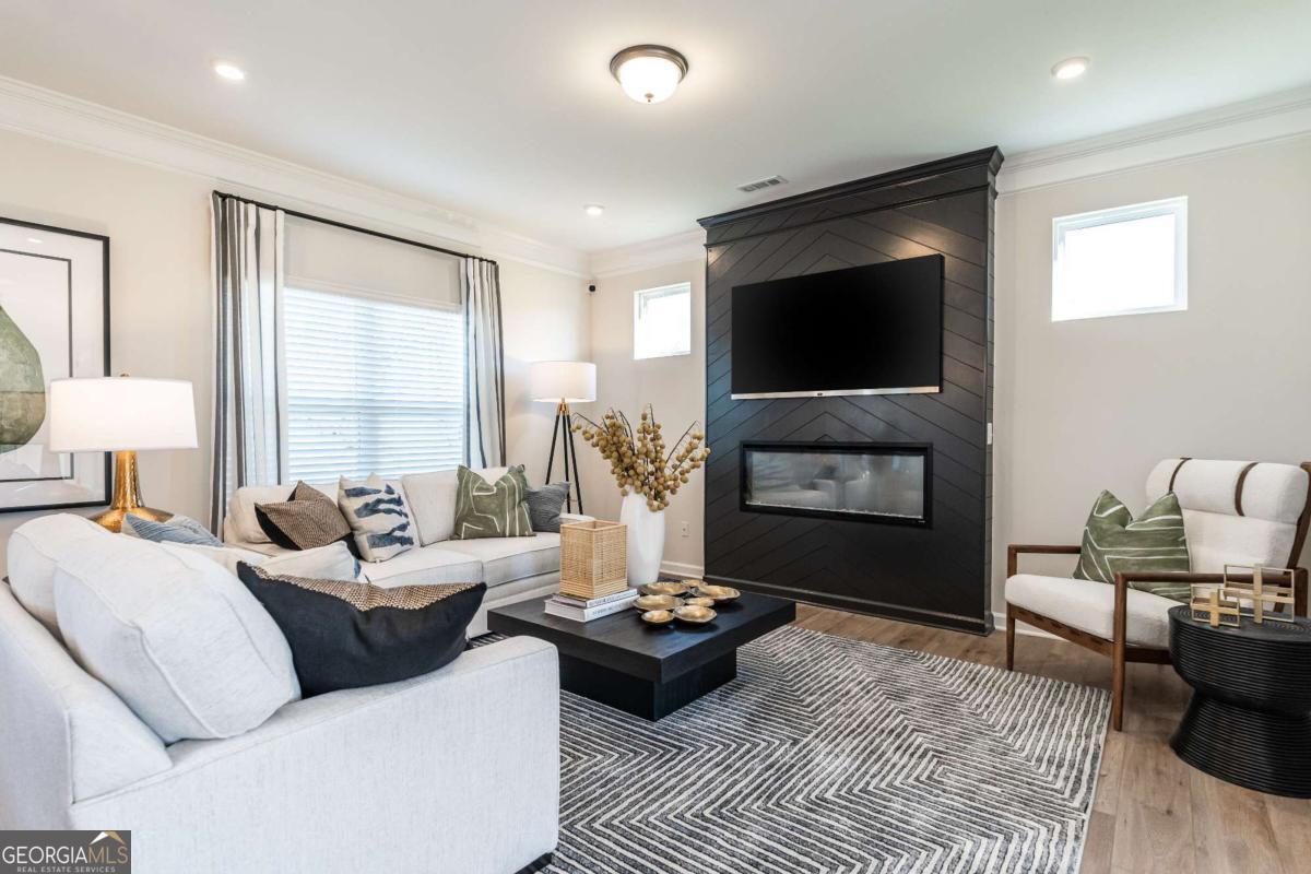 10413 Trellis Lane, Unit (LOT 33) Hampton, GA 30228 - Photo 12 of 39 a living room with furniture and a flat screen tv