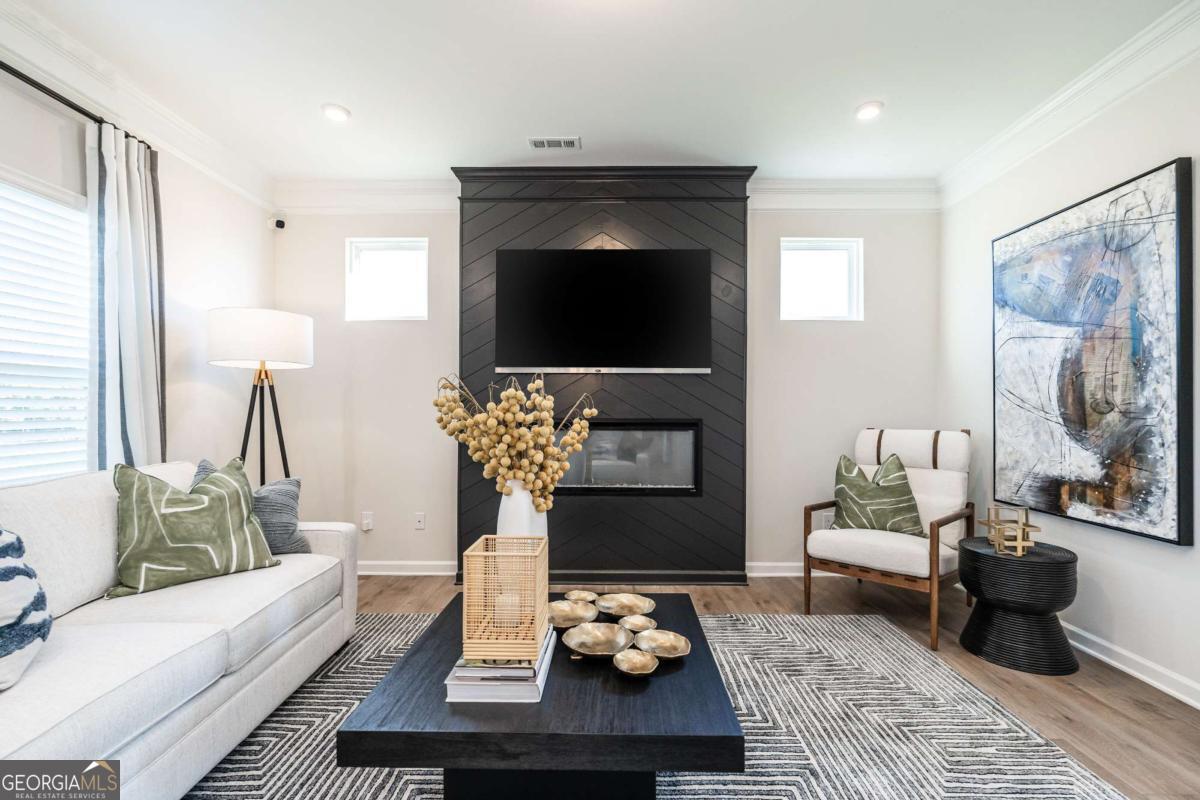 10413 Trellis Lane, Unit (LOT 33) Hampton, GA 30228 - Photo 13 of 39 a living room with furniture and a fireplace
