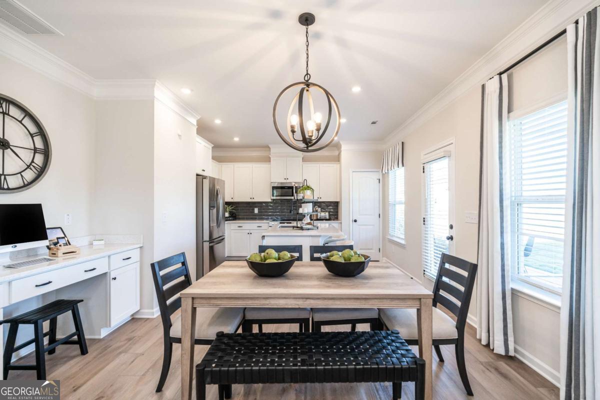 10413 Trellis Lane, Unit (LOT 33) Hampton, GA 30228 - Photo 16 of 39 a view of a dining room with furniture window and wooden floor
