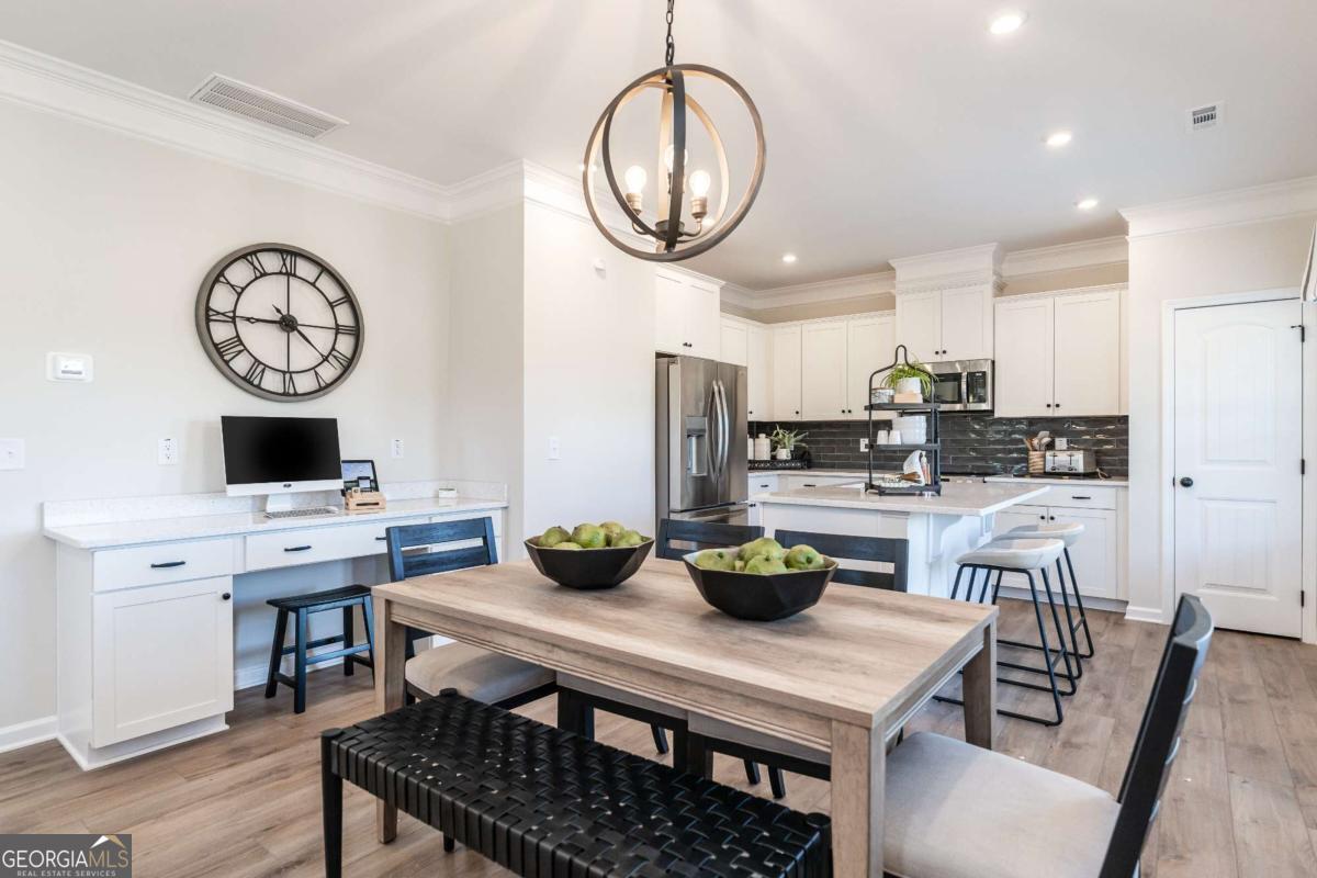10413 Trellis Lane, Unit (LOT 33) Hampton, GA 30228 - Photo 17 of 39 a kitchen with a table and chairs