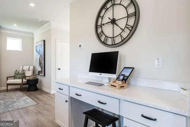 a work room with furniture and a flat screen tv