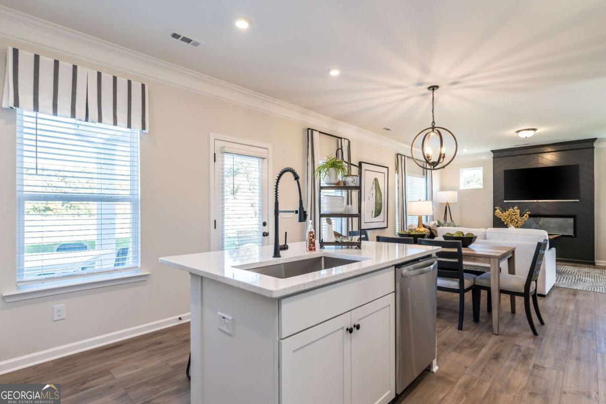 10413 Trellis Lane, Unit (LOT 33) Hampton, GA 30228 - Photo 23 of 39 a very nice looking dining room with a large window and wooden floors