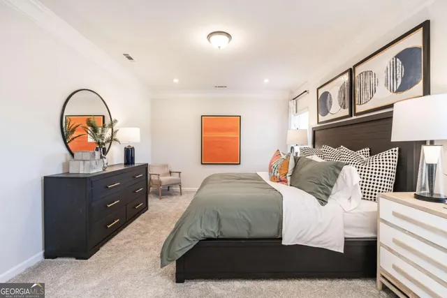 a bedroom with a bed and a painting on the wall