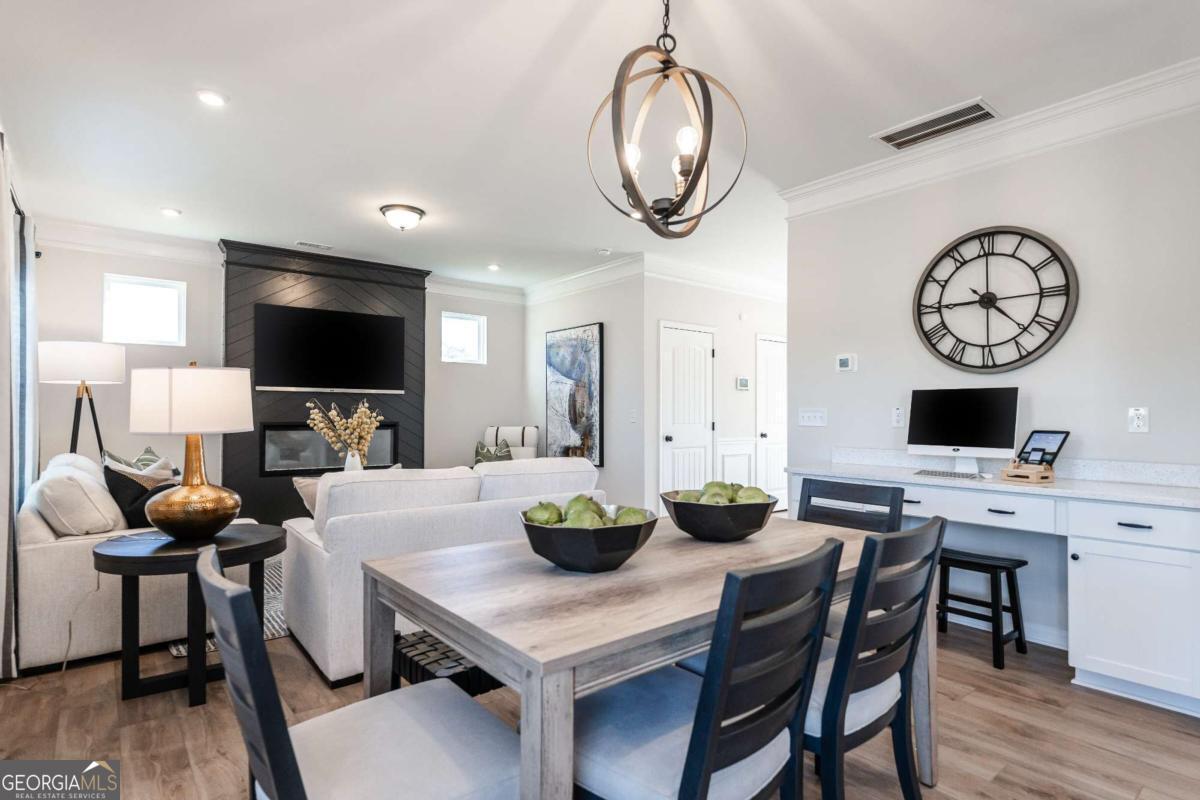 10413 Trellis Lane, Unit (LOT 33) Hampton, GA 30228 - Photo 25 of 39 a view of a dining room with furniture and wooden floor