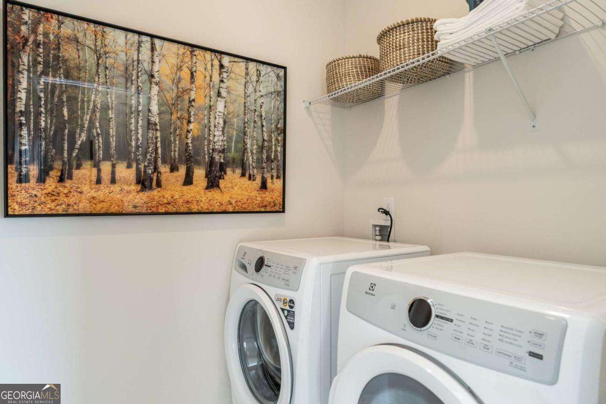 10413 Trellis Lane, Unit (LOT 33) Hampton, GA 30228 - Photo 29 of 39 a utility room with dryer and washer