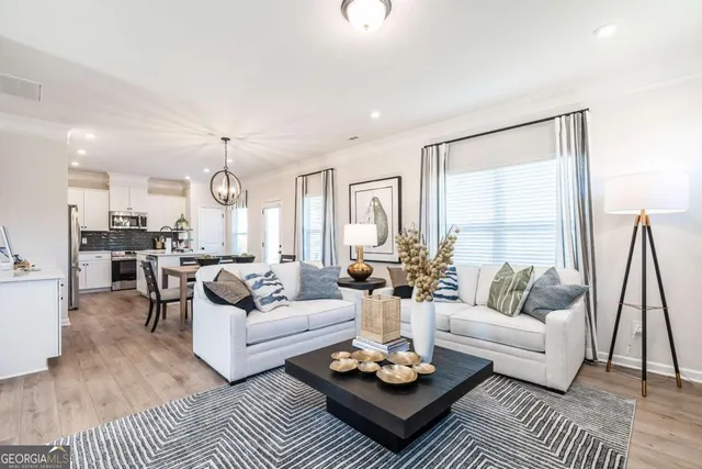 a living room with furniture kitchen view and a table