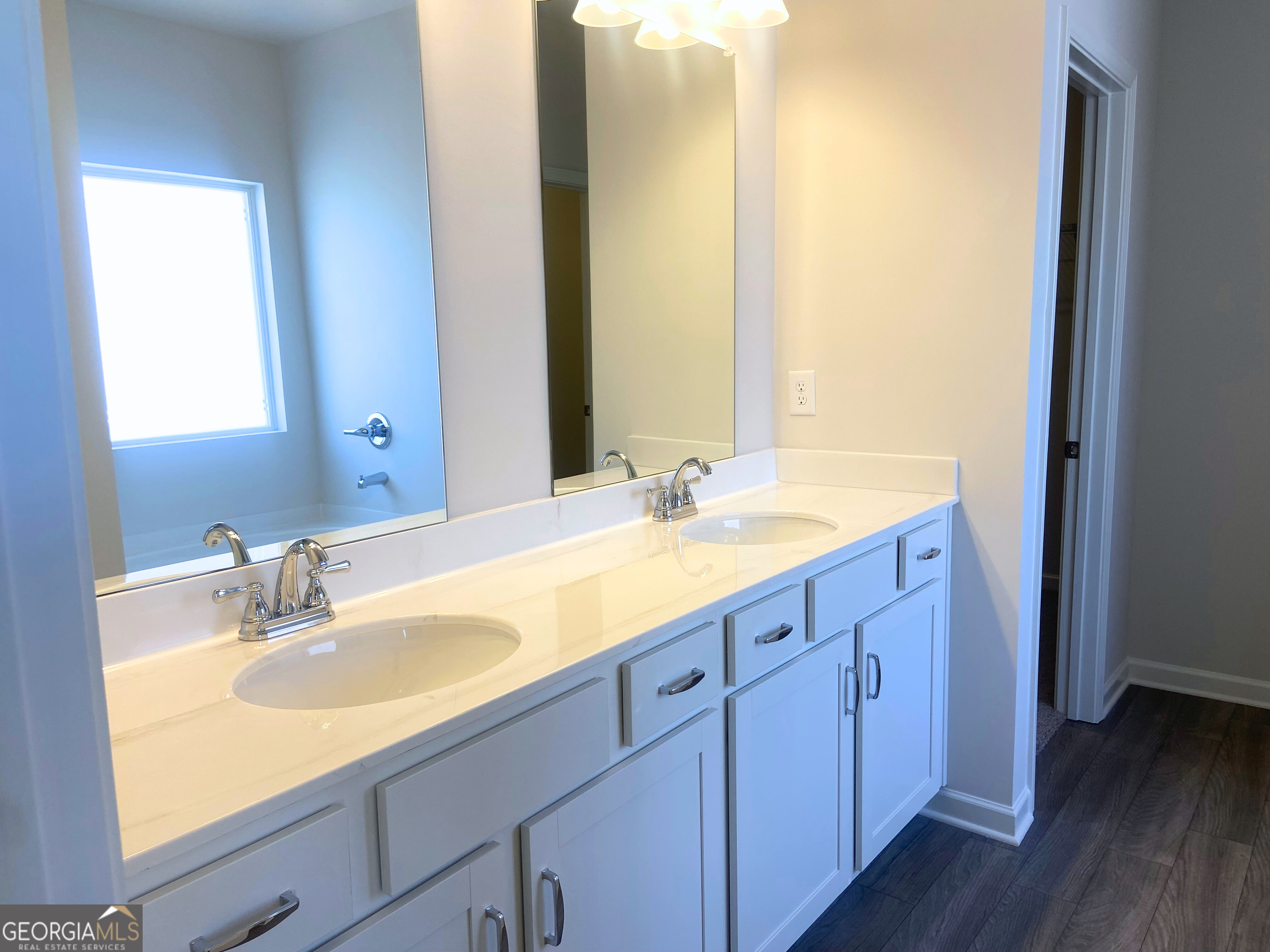 10413 Trellis Lane, Unit (LOT 33) Hampton, GA 30228 - Photo 7 of 39 a bathroom with a double vanity sink and a mirror
