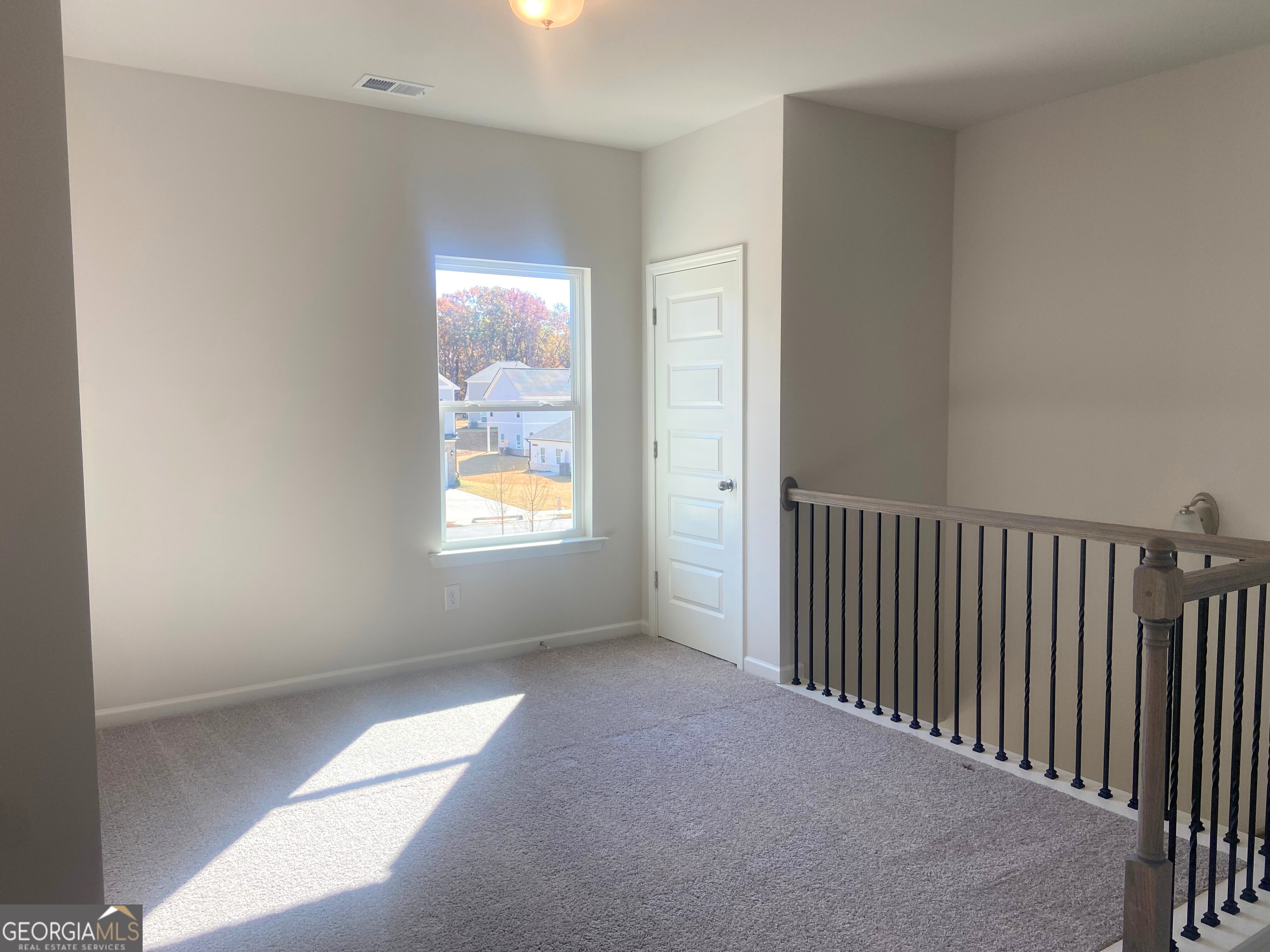 10413 Trellis Lane, Unit (LOT 33) Hampton, GA 30228 - Photo 8 of 39 a view of hallway with window