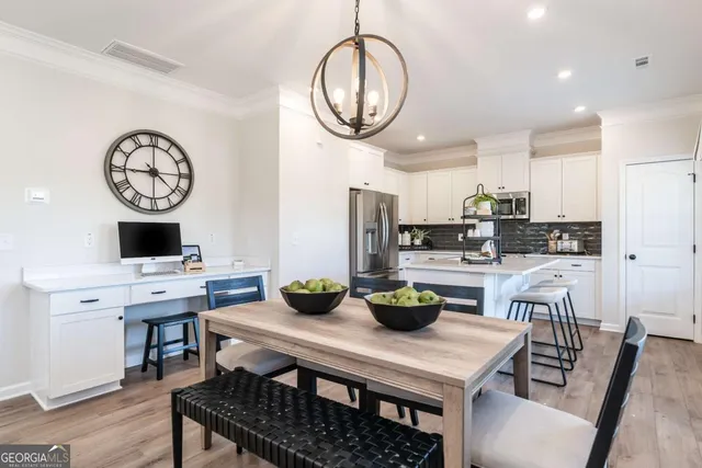 a kitchen with a table and chairs