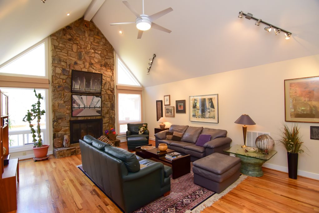 6909 Slade Hill Road Raleigh, NC 27615 - Photo 10 of 25 2nd shot of family room showing front vaulted entry in background, dimmered lighting, hardwood floors and overall grand scale. Family Room