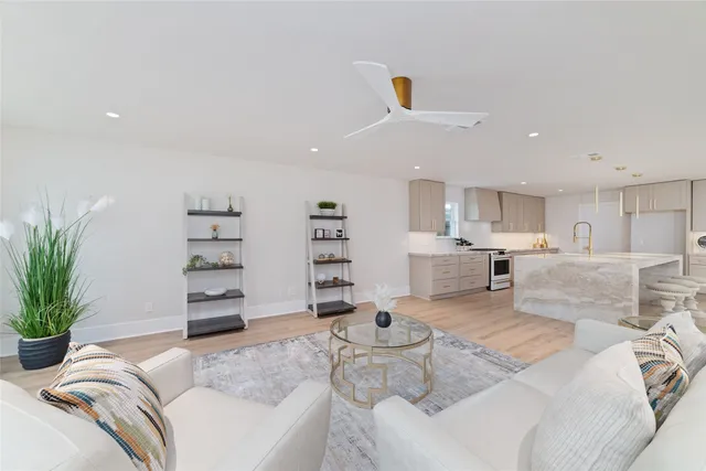 a living room with furniture and a kitchen
