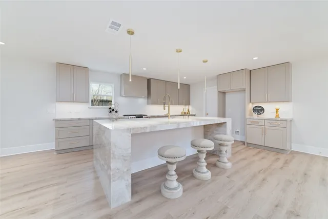 a kitchen with white cabinets and appliances