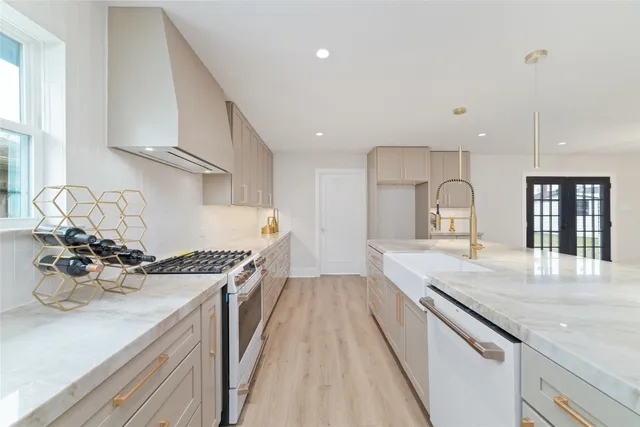 a kitchen with a sink stove and cabinets