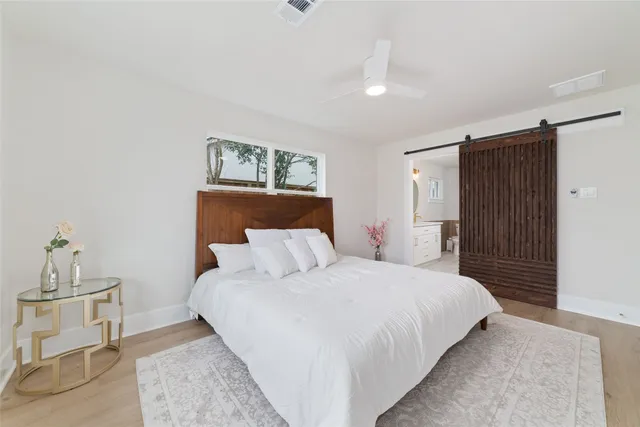 a bedroom with a bed and a table