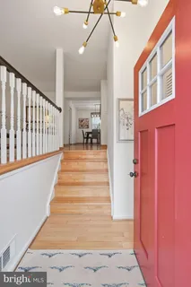 a view of entryway and hall with wooden floor