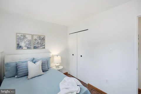 a bedroom with a bed and a painting on the wall