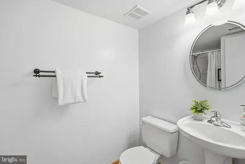 a white toilet sitting next to a bathroom sink