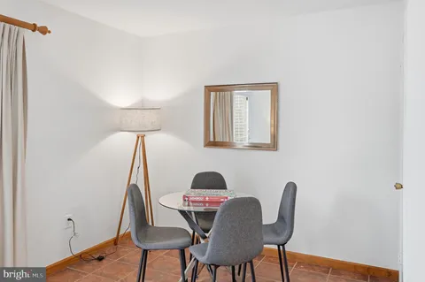 a view of a workspace with furniture and wooden floor
