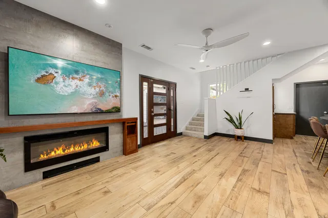 a view of an empty room with a fireplace and a window