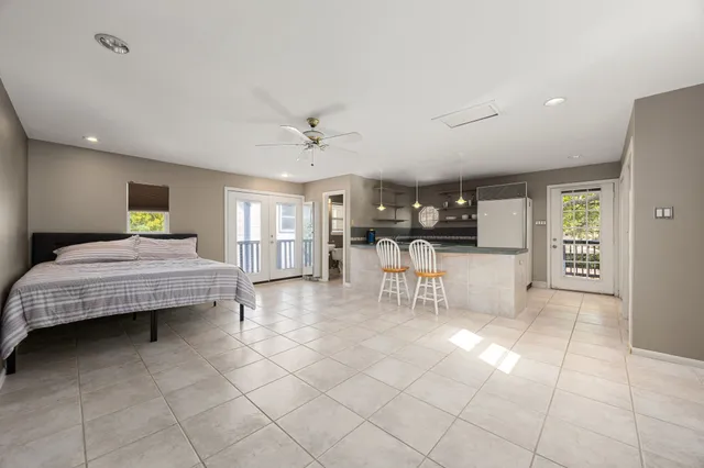 a living room with furniture and kitchen view