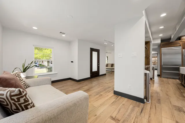 a living room with couches and a flat screen tv