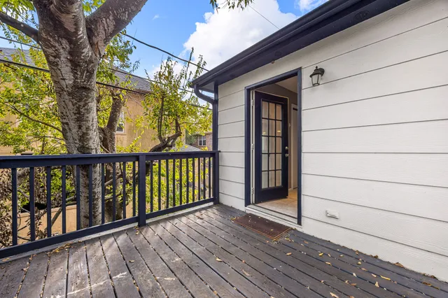 a view of a balcony with wooden floor