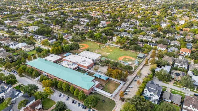 an aerial view of a house with a yard