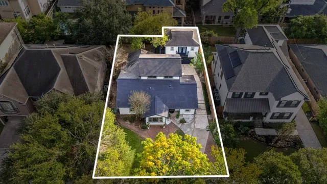 an aerial view of a house with swimming pool and sitting space