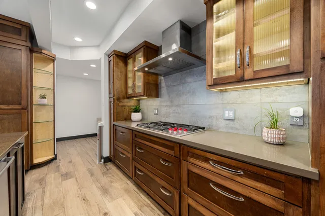 a kitchen with stainless steel appliances a stove a refrigerator and cabinets